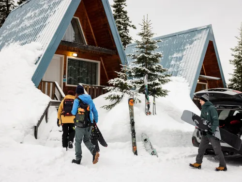 Skiers check in to an A-frame chalet at Powder King, BC.